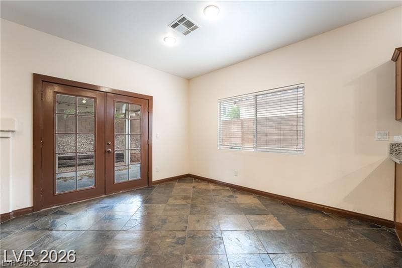 10605 Bardilino Street, Las Vegas, NV 89141 Rich tile flooring anchors this dining space featuring glass French doors to the patio.