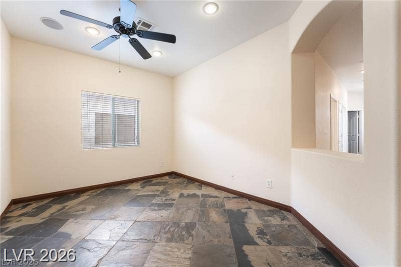 10605 Bardilino Street, Las Vegas, NV 89141 Natural stone tile floors and a recessed wall opening define this versatile living space.