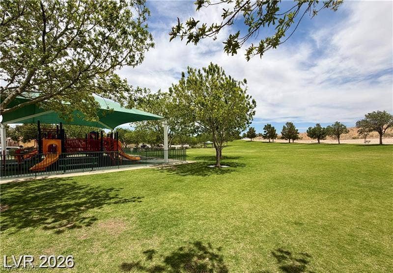 10605 Bardilino Street, Las Vegas, NV 89141 Mature trees shade a neighborhood park with a modern playground and expansive green lawn.