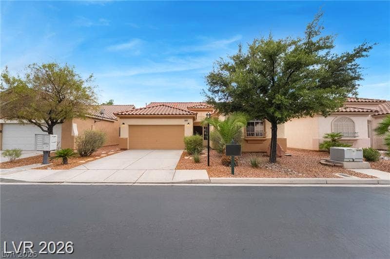 10605 Bardilino Street, Las Vegas, NV 89141 Spanish tile roofing and desert-style landscaping enhance the exterior of this single-story home.