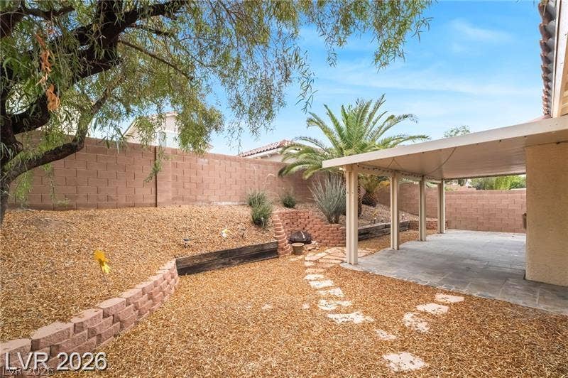10605 Bardilino Street, Las Vegas, NV 89141 An inviting covered patio opens to a multi-level yard bordered by block walls.