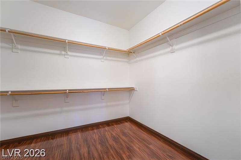 10605 Bardilino Street, Las Vegas, NV 89141 Rich wood flooring grounds this generous storage space featuring wrap-around shelving and hanging rods.