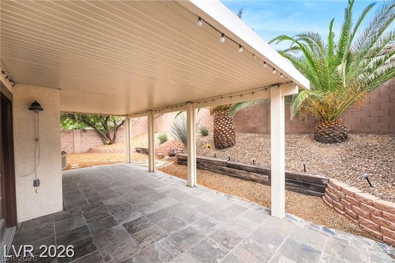 10605 Bardilino Street, Las Vegas, NV 89141 A spacious covered patio features durable slate tile flooring overlooking a tiered, low-maintenance backyard.