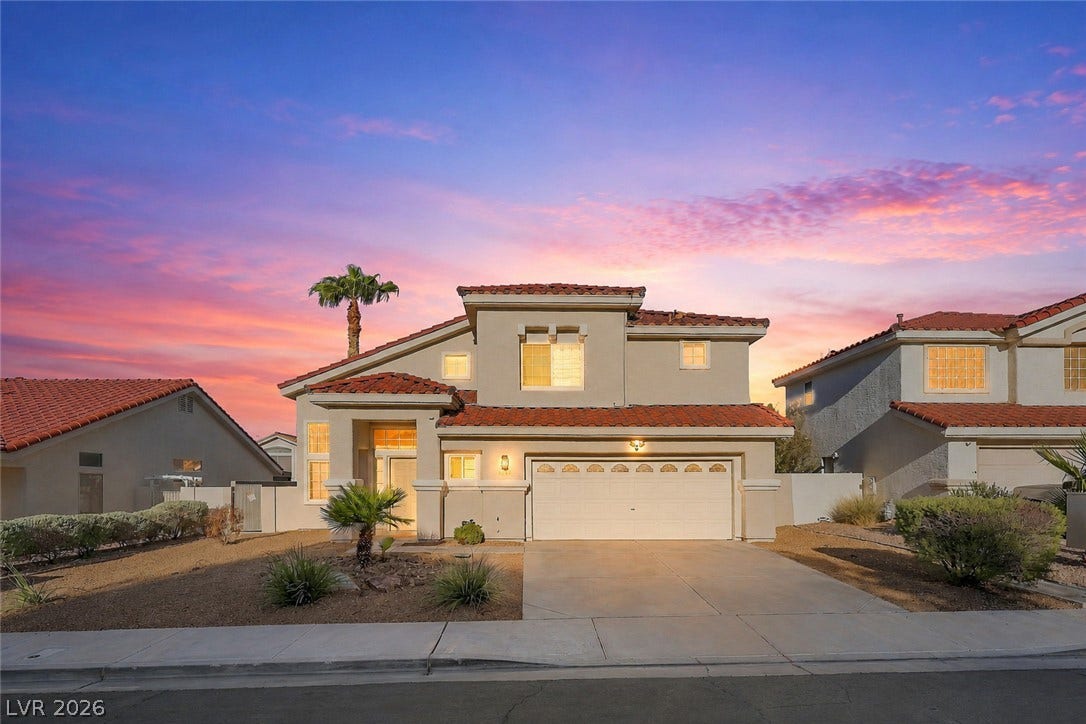 1874 Mesquite Canyon Drive, Henderson, NV 89012 Spanish tile roofing and desert plantings frame this striking two-story exterior.
