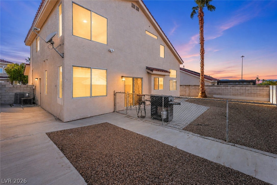 1874 Mesquite Canyon Drive, Henderson, NV 89012 An inviting backyard patio sits under a beautifully colored twilight sky.