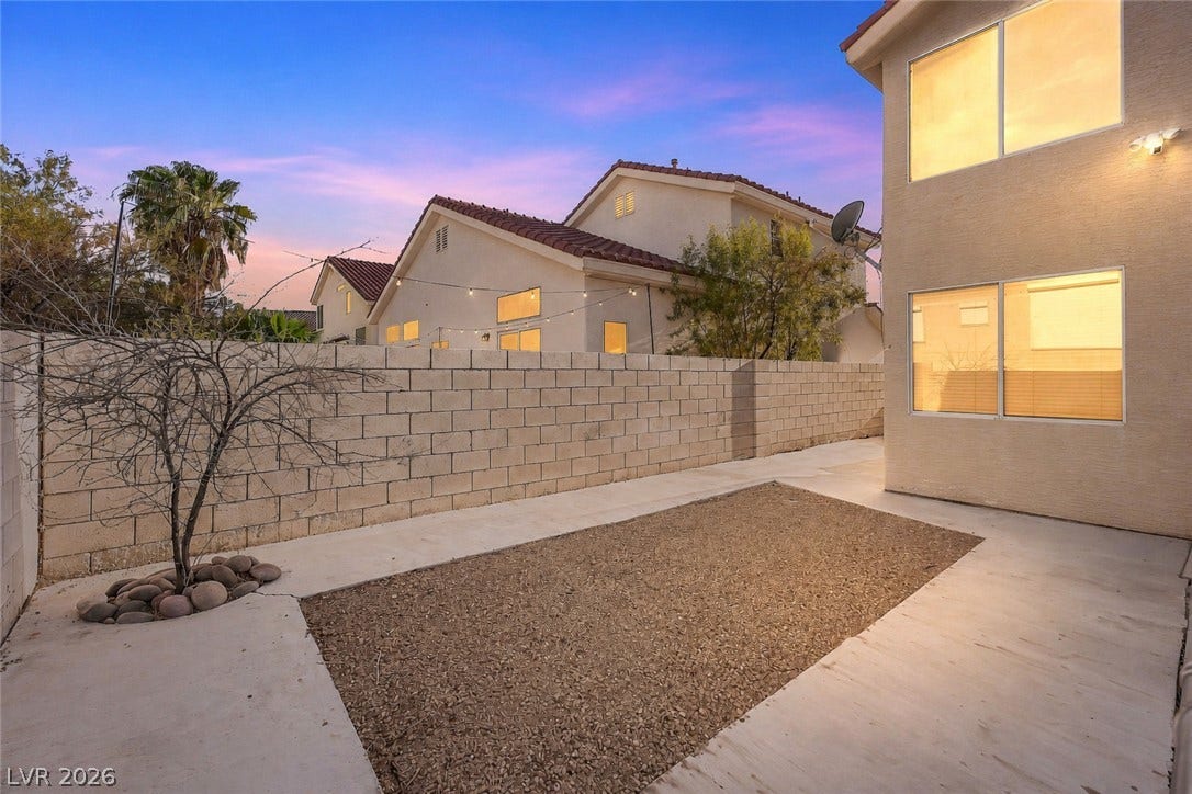 1874 Mesquite Canyon Drive, Henderson, NV 89012 An enclosed backyard features concrete walkways, low-maintenance gravel, and a sturdy block wall.