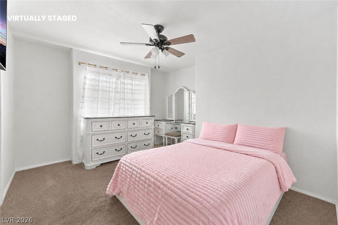 1874 Mesquite Canyon Drive, Henderson, NV 89012 Plush carpeting and a large window create a comfortable, inviting atmosphere.