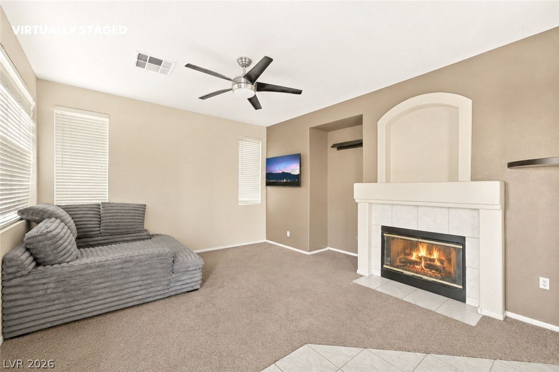 1874 Mesquite Canyon Drive, Henderson, NV 89012 An inviting fireplace serves as the centerpiece of this comfortable living space.