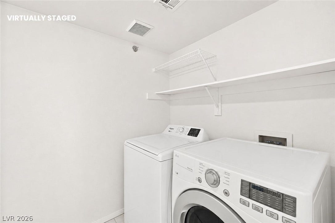1874 Mesquite Canyon Drive, Henderson, NV 89012 An organized laundry area includes built-in shelving over a modern washer and dryer set.