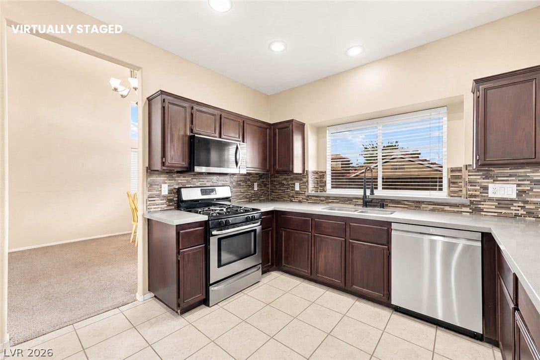 1874 Mesquite Canyon Drive, Henderson, NV 89012 Rich dark wood cabinetry pairs with durable tile flooring and clean countertops.