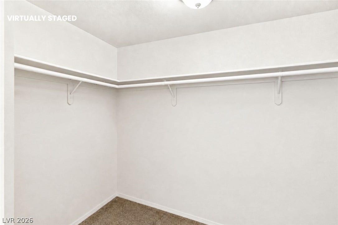 1874 Mesquite Canyon Drive, Henderson, NV 89012 Ample hanging rods and built-in shelving maximize storage potential in this carpeted closet.