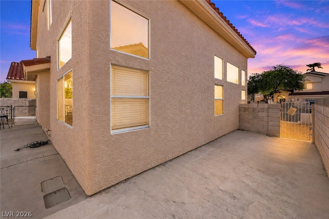 1874 Mesquite Canyon Drive, Henderson, NV 89012 Textured stucco exterior walls pair with concrete patios and multi-level windows.