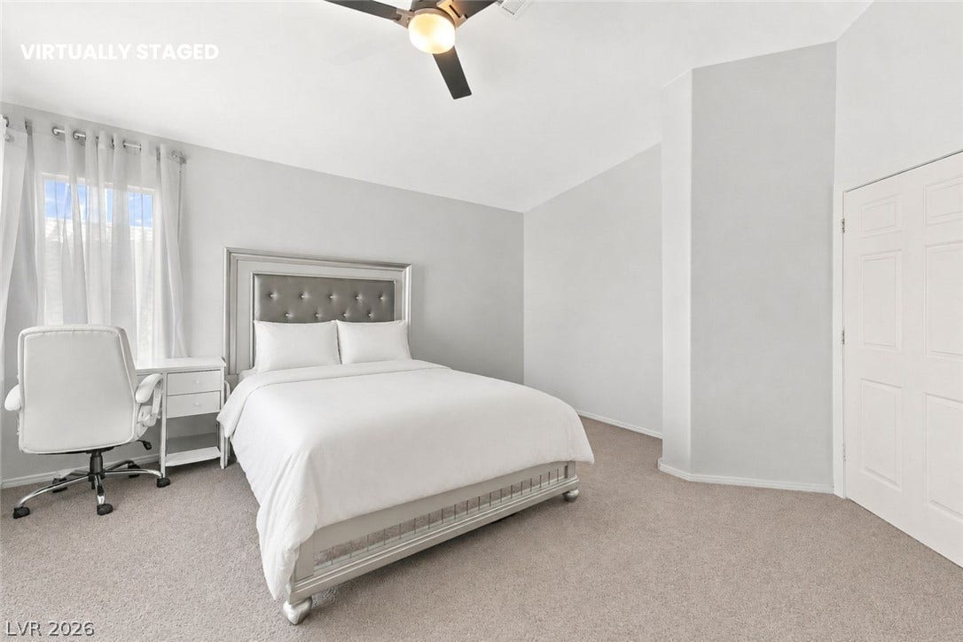 1874 Mesquite Canyon Drive, Henderson, NV 89012 A spacious bedroom offers plush carpeting and a high vaulted ceiling.