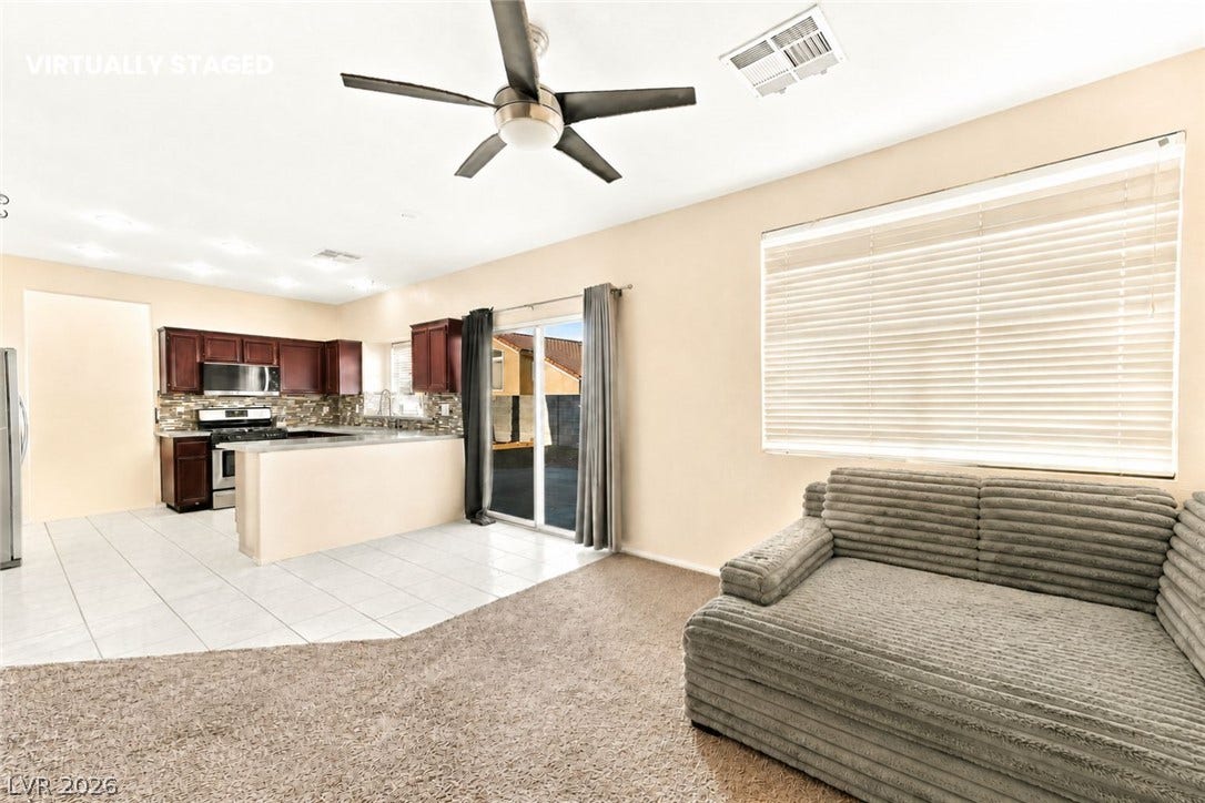 1874 Mesquite Canyon Drive, Henderson, NV 89012 An open floor plan flows seamlessly from the carpeted living space into the tiled kitchen.