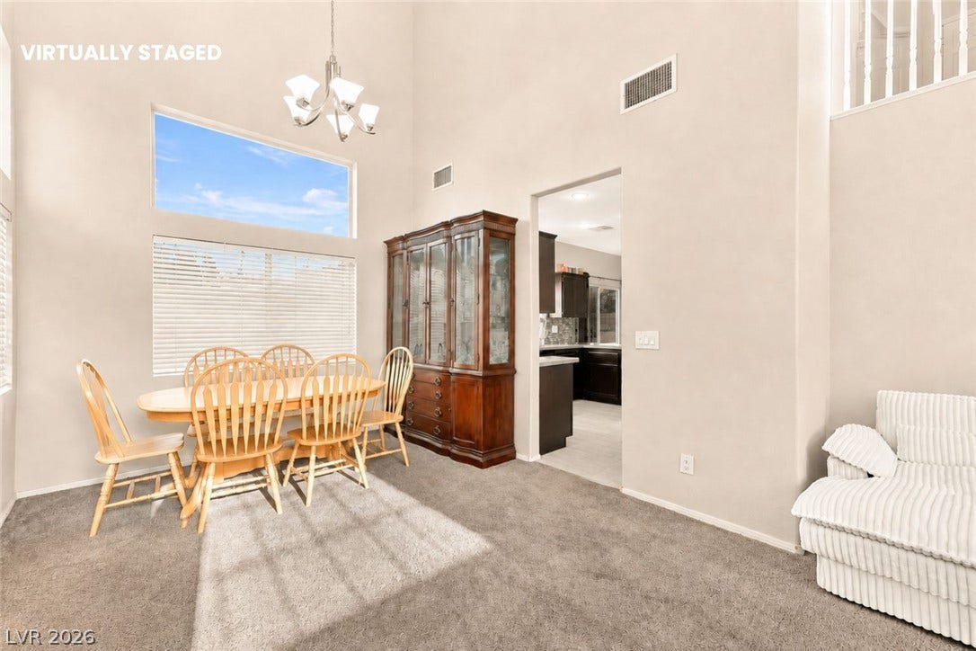 1874 Mesquite Canyon Drive, Henderson, NV 89012 High ceilings and generous windows define this open dining space leading into the kitchen.