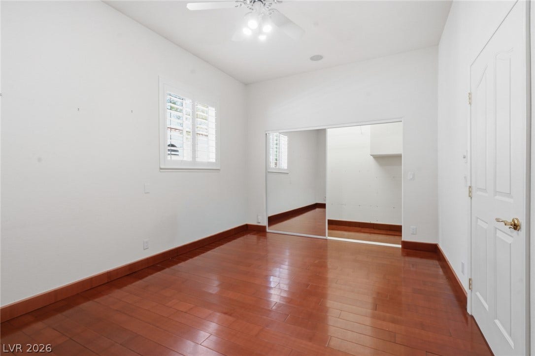 2212 Chatsworth Court, Henderson, NV 89074 Rich hardwood flooring complements a practical mirrored closet in this adaptable space.