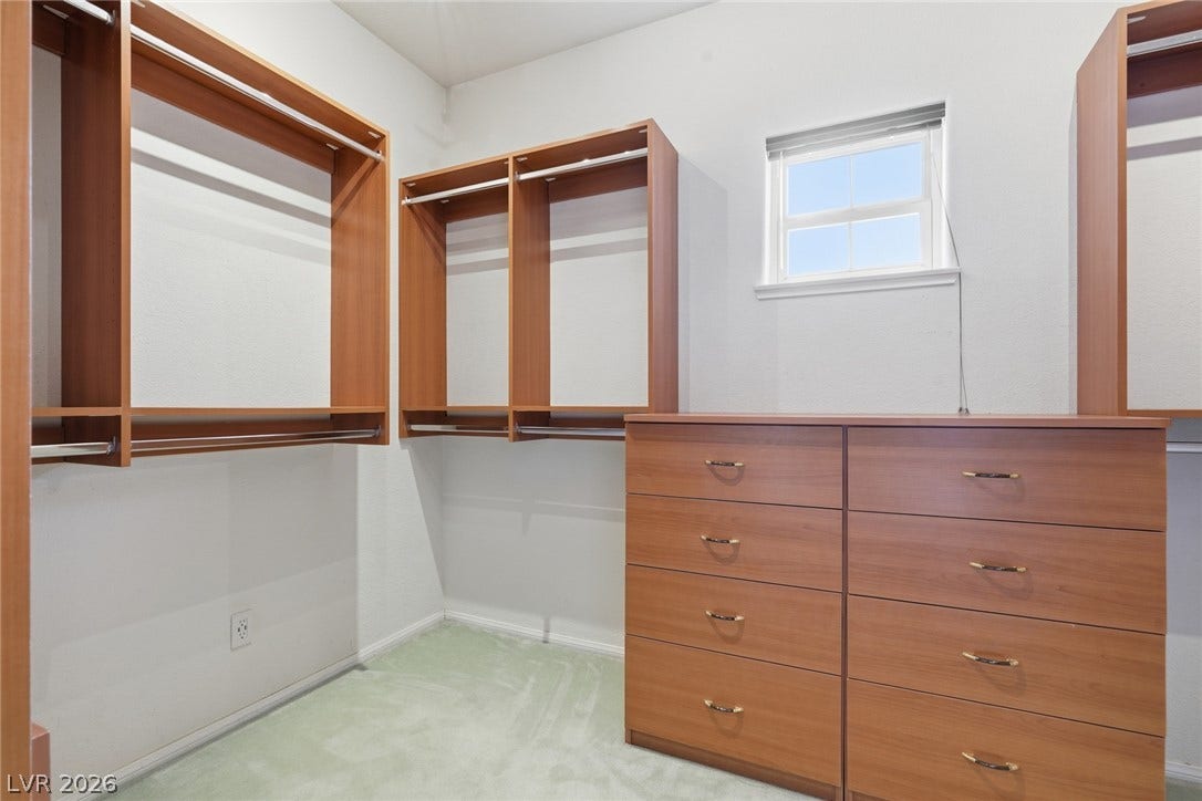 2212 Chatsworth Court, Henderson, NV 89074 Custom shelving and drawer units optimize storage space in this well-appointed walk-in closet.