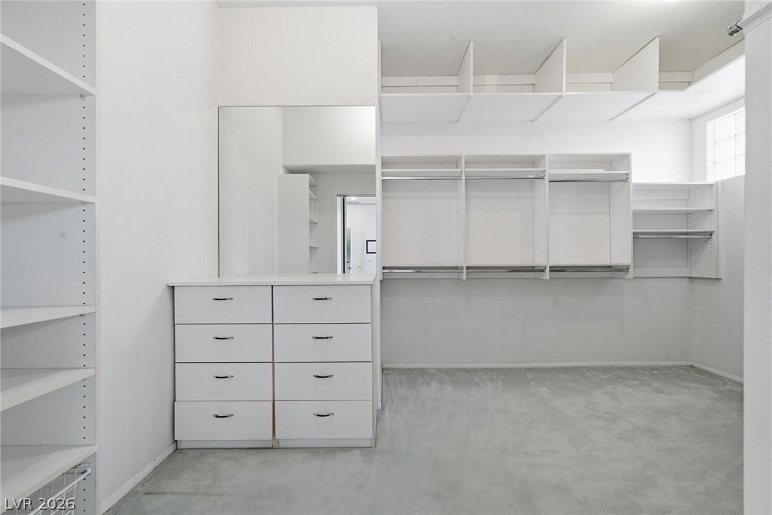 2212 Chatsworth Court, Henderson, NV 89074 An organized walk-in closet with ample shelving and built-in drawers offers convenient storage.