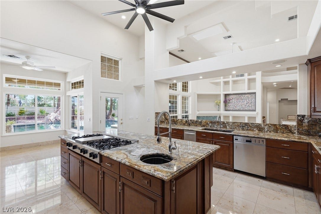 2212 Chatsworth Court, Henderson, NV 89074 Culinary excellence meets effortless living in this sun-drenched kitchen with soaring ceilings and a tranquil pool view.
