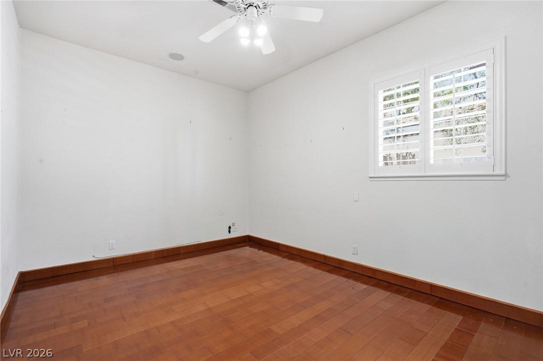 2212 Chatsworth Court, Henderson, NV 89074 Hardwood floors and a bright window with shutters define this appealing secondary room.