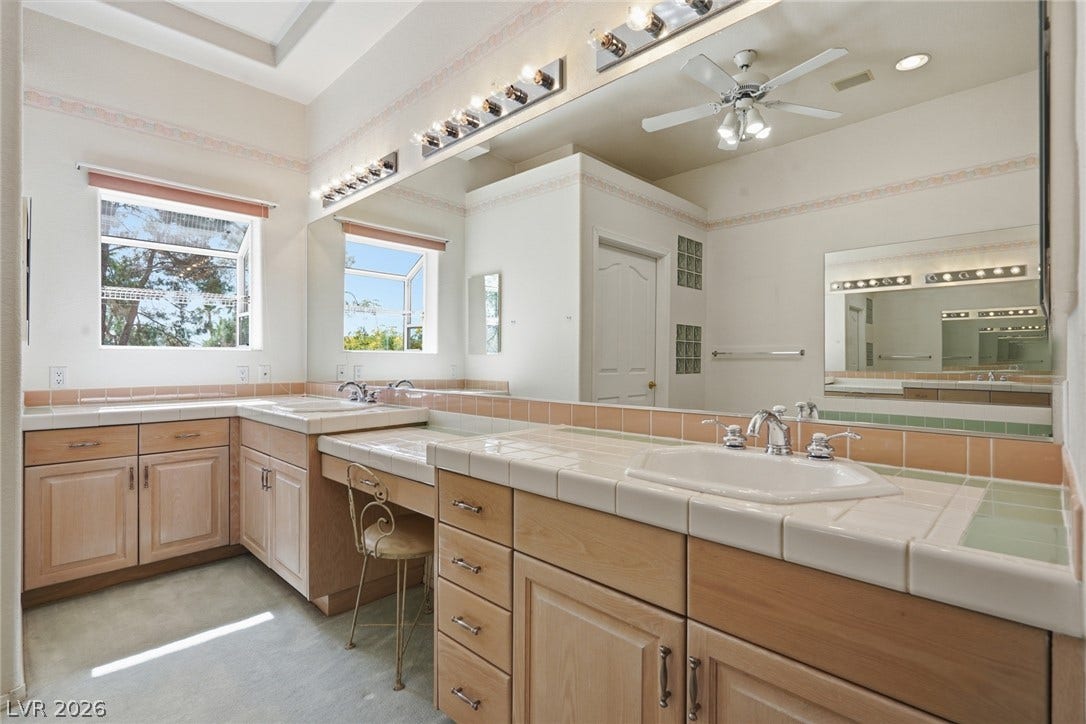 2212 Chatsworth Court, Henderson, NV 89074 A generously sized bathroom features dual vanities and a light, airy ambiance with multiple windows.