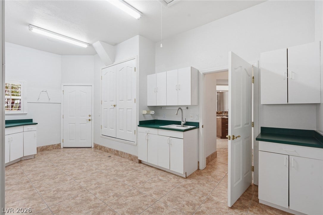 2212 Chatsworth Court, Henderson, NV 89074 A well-appointed utility room features abundant storage cabinetry and practical countertop space.
