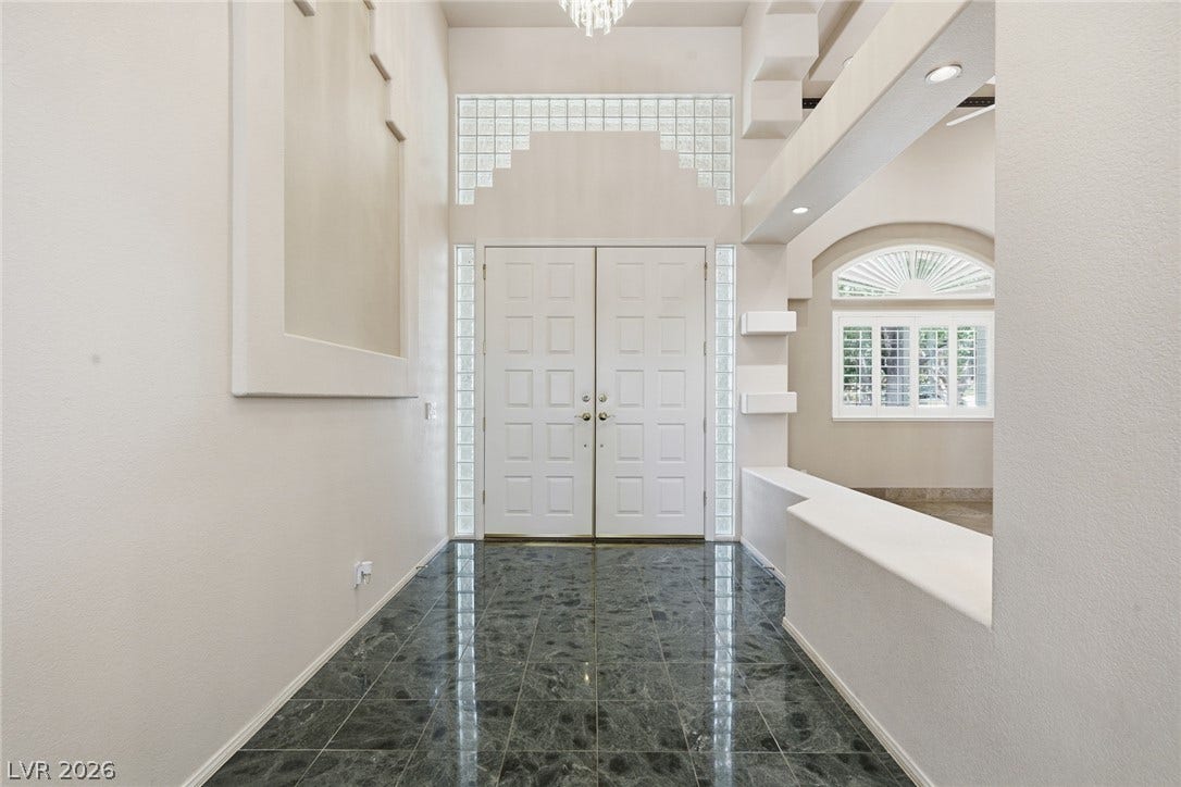 2212 Chatsworth Court, Henderson, NV 89074 A grand double door entry welcomes with a dazzling chandelier and polished tile flooring.