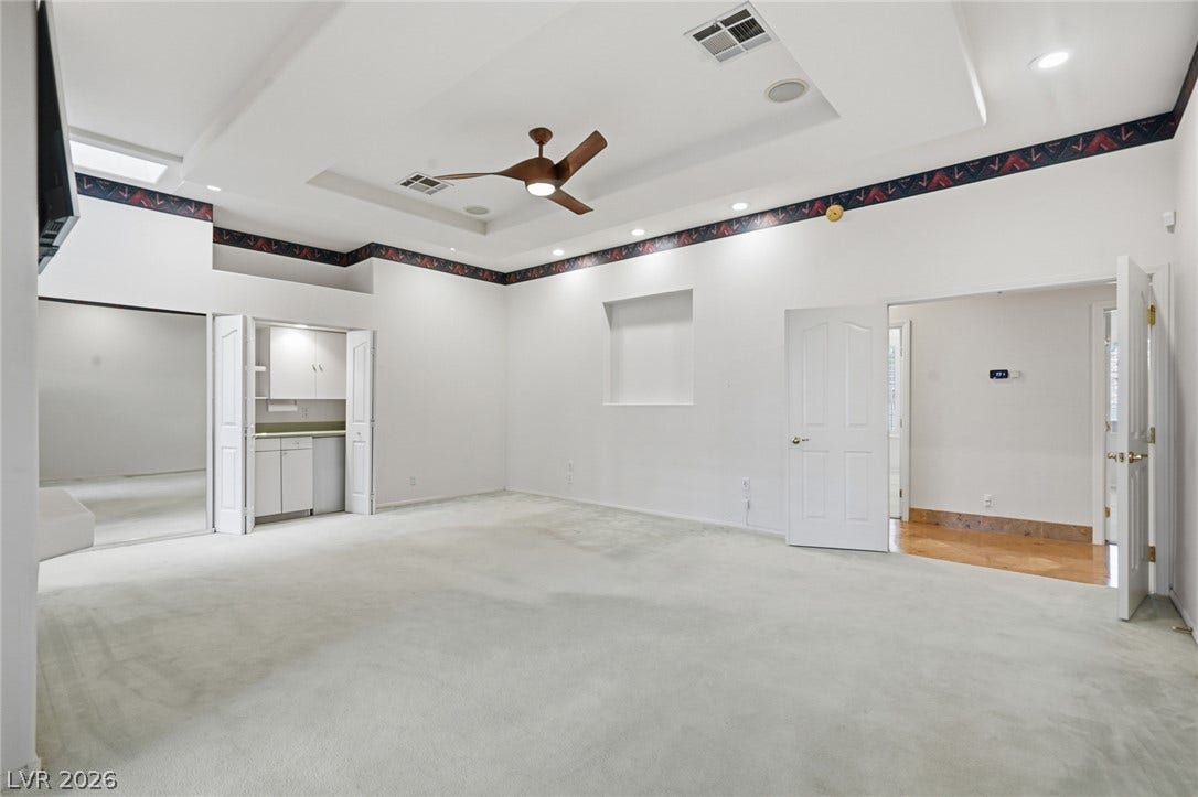 2212 Chatsworth Court, Henderson, NV 89074 A spacious room offers comfortable carpeted flooring and a convenient built-in wet bar.