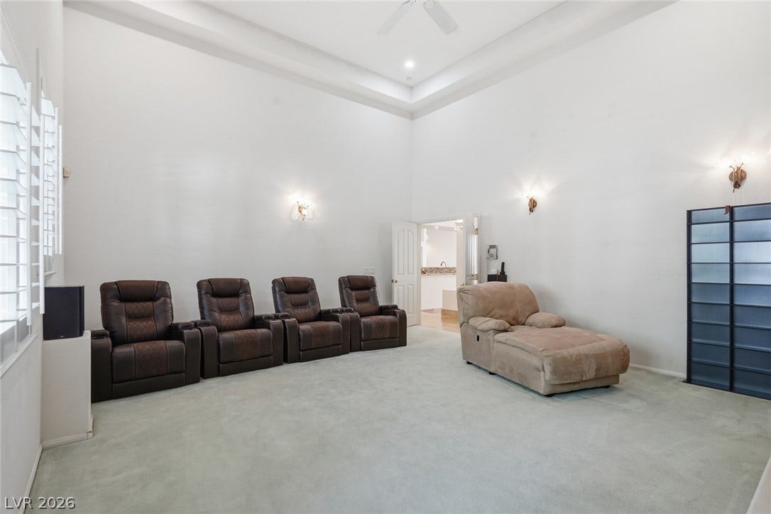 2212 Chatsworth Court, Henderson, NV 89074 Theater seating and high ceilings define this comfortable media room, perfect for entertainment.