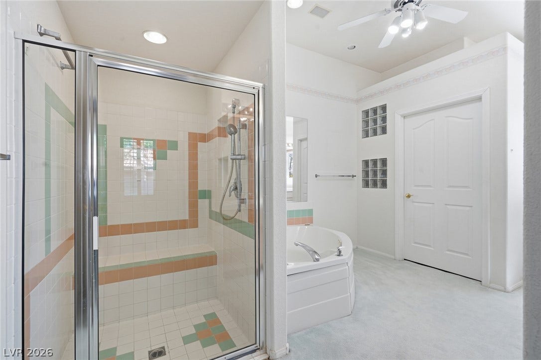 2212 Chatsworth Court, Henderson, NV 89074 A corner soaking tub and glass-enclosed shower create a luxurious bathroom retreat.