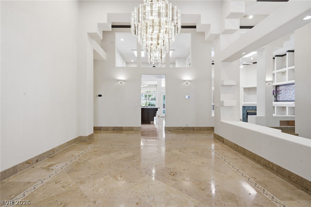 2212 Chatsworth Court, Henderson, NV 89074 A grand entrance with high ceilings welcomes you, adorned by a dazzling chandelier and polished tile floors.