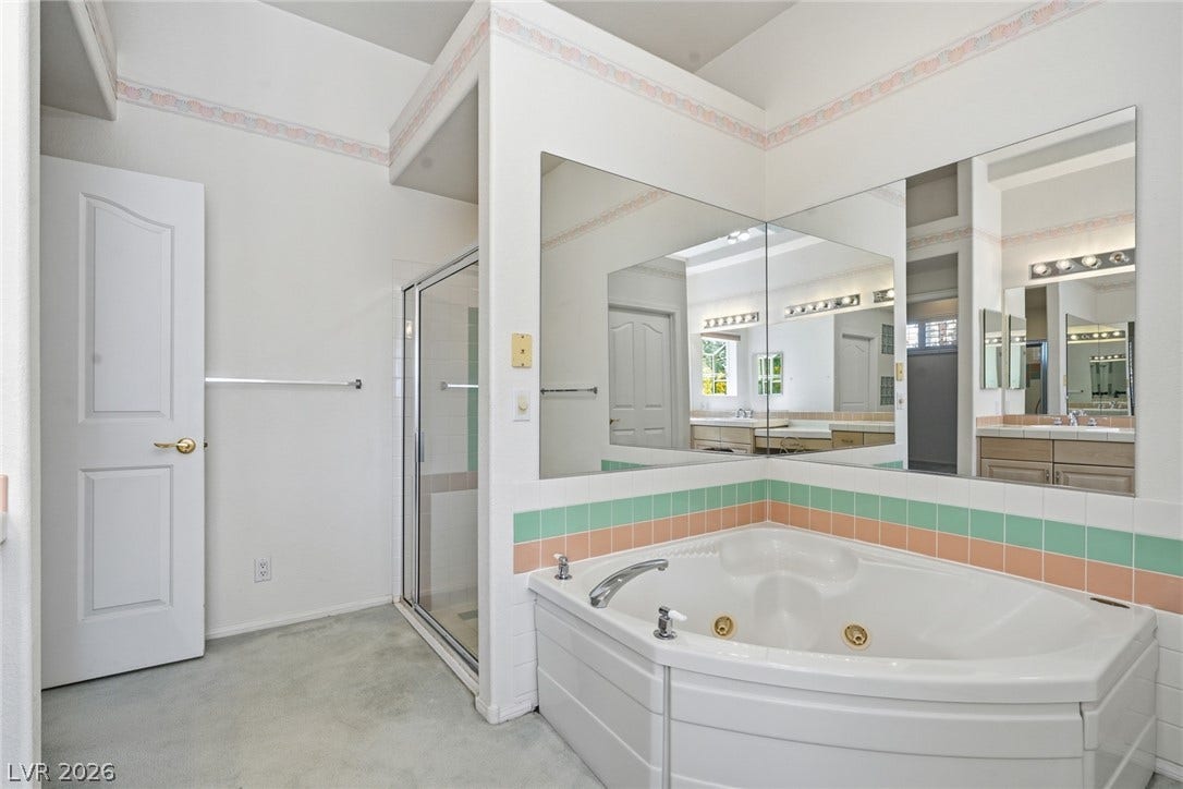 2212 Chatsworth Court, Henderson, NV 89074 Indulge in relaxation within this primary bathroom featuring a corner soaking tub and glass-enclosed shower.