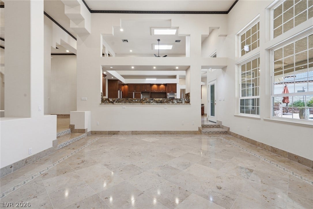 2212 Chatsworth Court, Henderson, NV 89074 Grand living area with soaring ceilings and luminous tile floors, inviting abundant natural light.