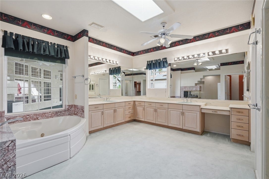 2212 Chatsworth Court, Henderson, NV 89074 Luxurious primary bath features a soaking tub, dual vanities, and a fireplace for ultimate relaxation.