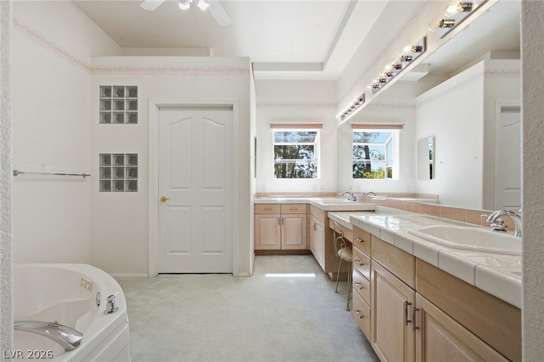 2212 Chatsworth Court, Henderson, NV 89074 Indulge in a primary bathroom offering a separate soaking tub and ample counter space with dual vanities.