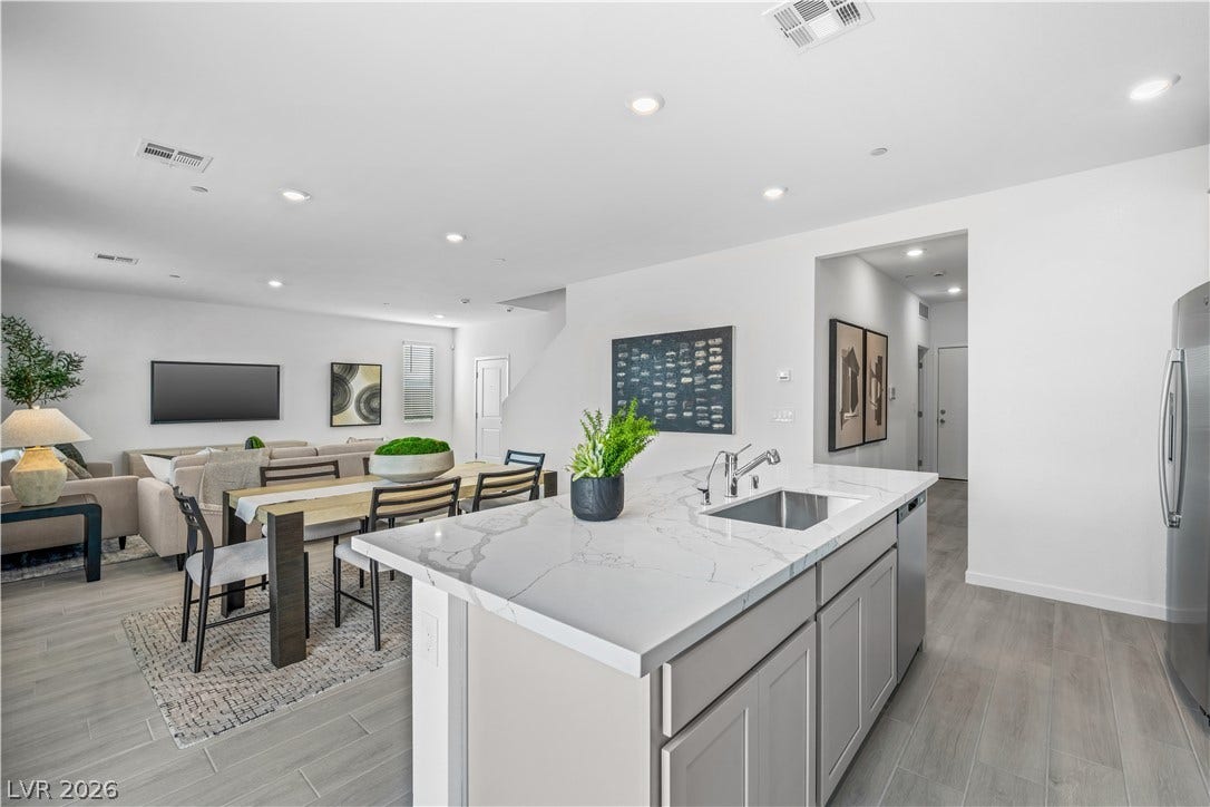 132 Harper Crest Avenue, Henderson, NV 89011 An open floorplan seamlessly connects the kitchen island to the dining and living spaces.