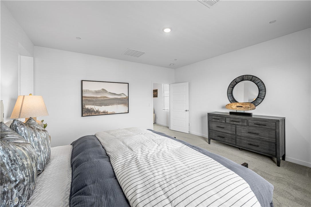 132 Harper Crest Avenue, Henderson, NV 89011 Recessed lighting and soft carpeting create a serene and restful atmosphere in this bedroom.