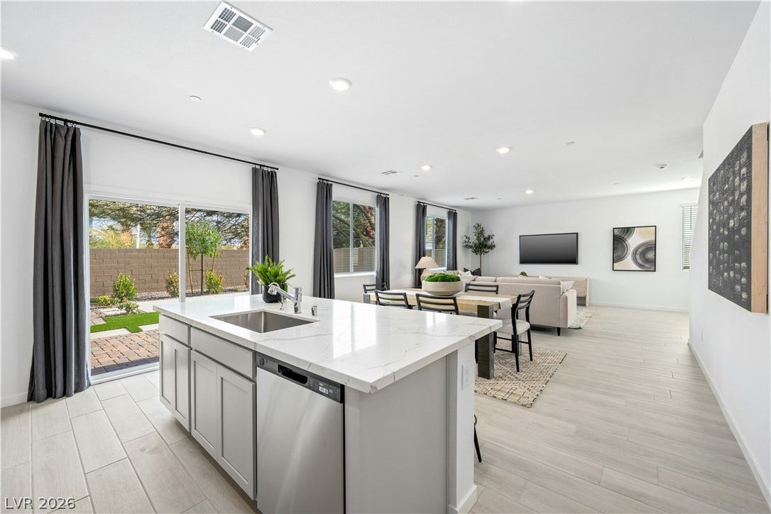 132 Harper Crest Avenue, Henderson, NV 89011 An open floor plan integrates the modern kitchen, dining area, and living space seamlessly.
