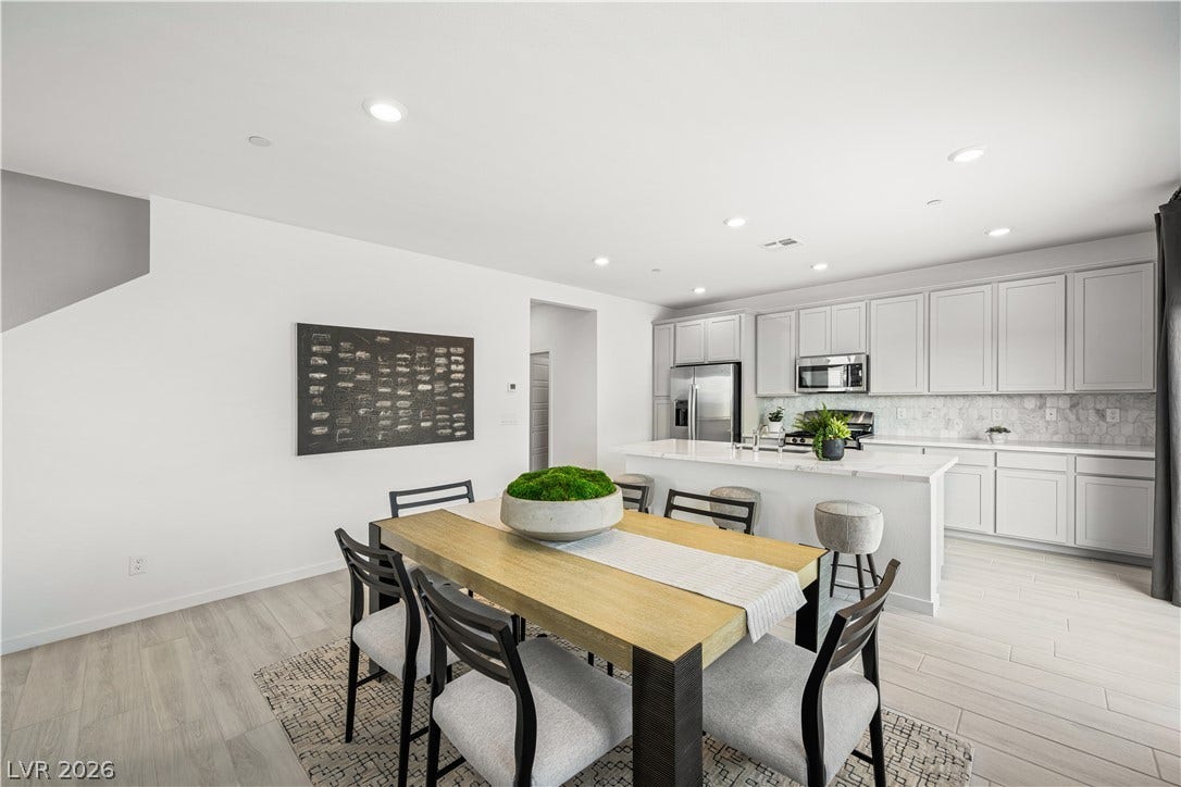 132 Harper Crest Avenue, Henderson, NV 89011 An open-concept layout connects the light-filled dining space directly to a modern kitchen.