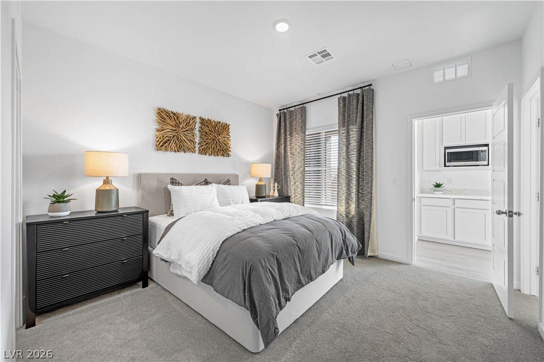 132 Harper Crest Avenue, Henderson, NV 89011 High ceilings and recessed lighting elevate this cozy bedroom suite with adjacent kitchenette access.