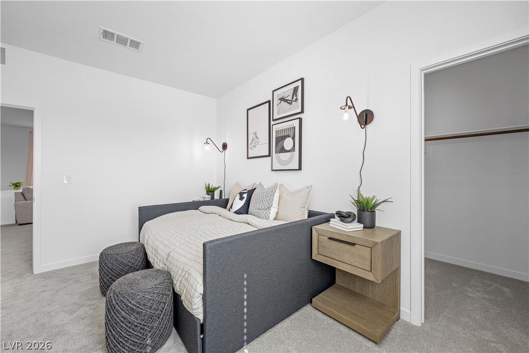132 Harper Crest Avenue, Henderson, NV 89011 Plush carpeting anchors this modern bedroom featuring clean lines and a nearby closet.