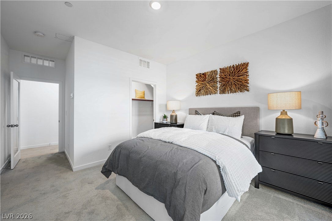 132 Harper Crest Avenue, Henderson, NV 89011 Recessed lighting and soft carpeting create a serene and comfortable atmosphere in this modern bedroom.