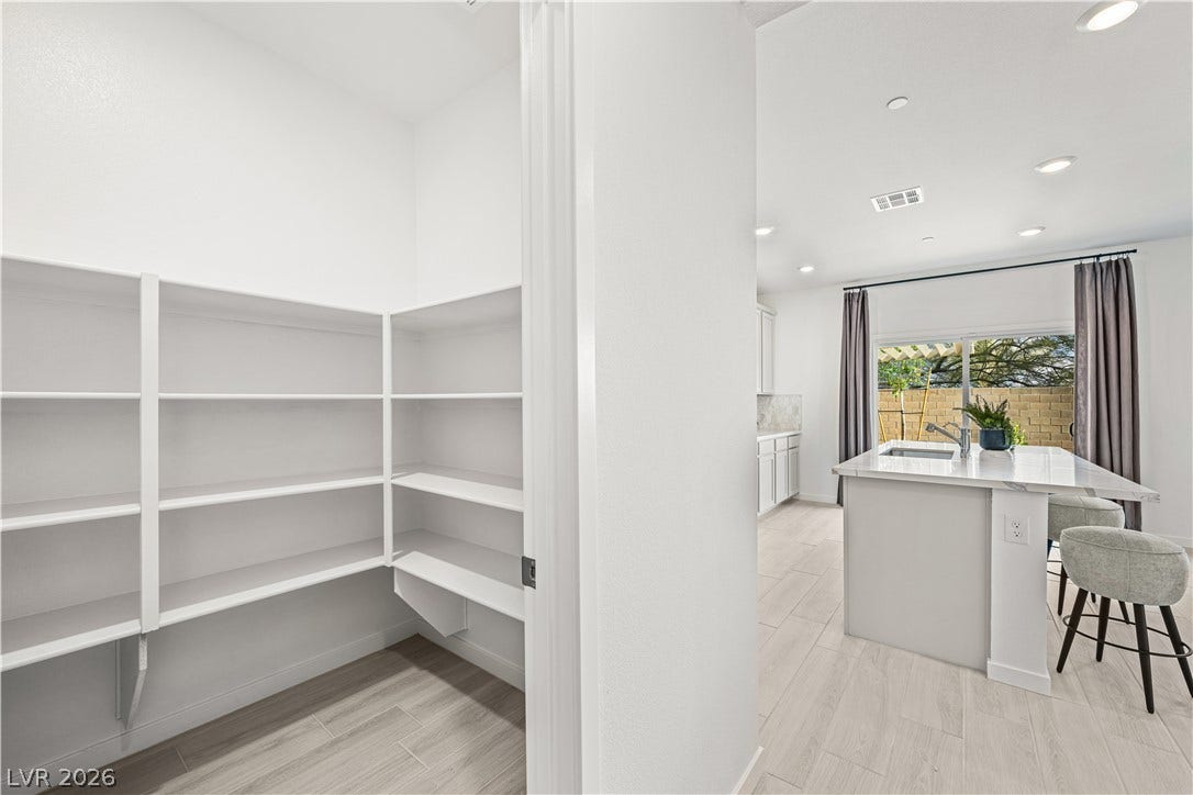 132 Harper Crest Avenue, Henderson, NV 89011 Ample built-in shelving maximizes storage potential adjacent to a modern, open-concept kitchen space.