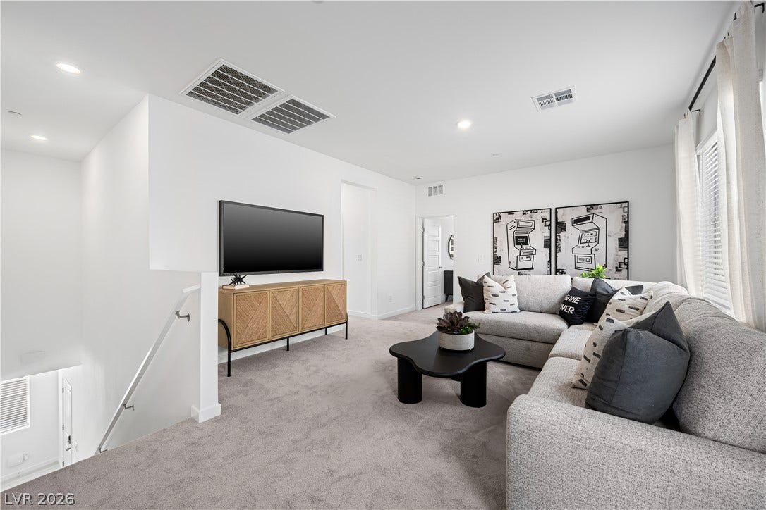 132 Harper Crest Avenue, Henderson, NV 89011 Recessed lighting illuminates this versatile upstairs loft featuring plush carpeting and an open staircase.