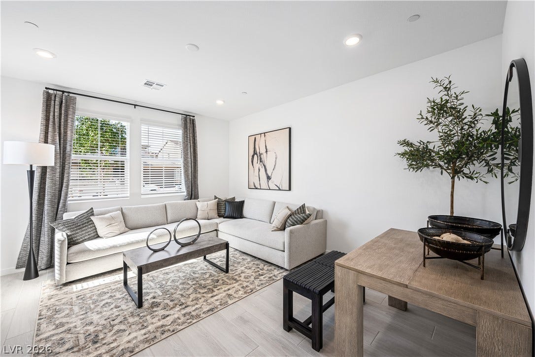 132 Harper Crest Avenue, Henderson, NV 89011 Recessed lighting illuminates this inviting living space featuring tile flooring and double windows.