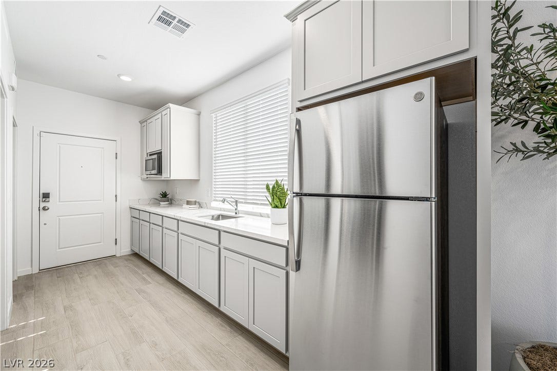 132 Harper Crest Avenue, Henderson, NV 89011 Recessed lighting and wood-look flooring enhance this modern culinary space.