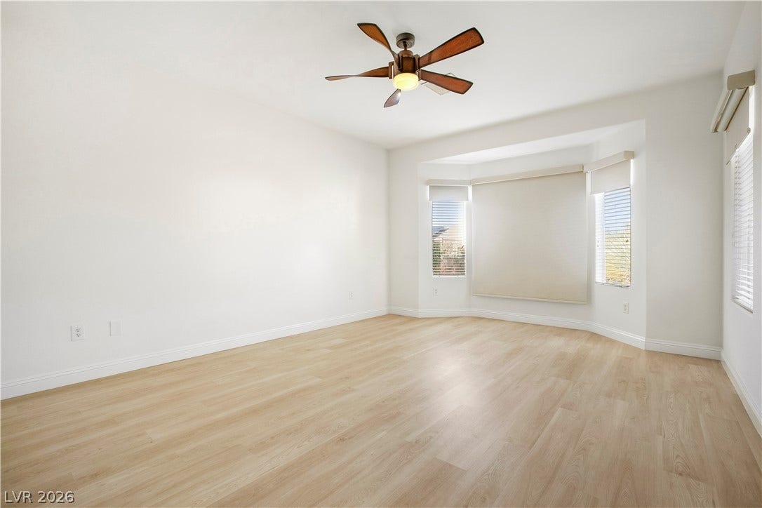 Owner's Suite with Bay Window, Ceiling Fan, Walk-In Closet w/ Organizers, and Bathroom with Raised Vanity, Dual Sinks, Shower w/ Seat, and Comfort Height Toilet w/ Bidet Heated Seat