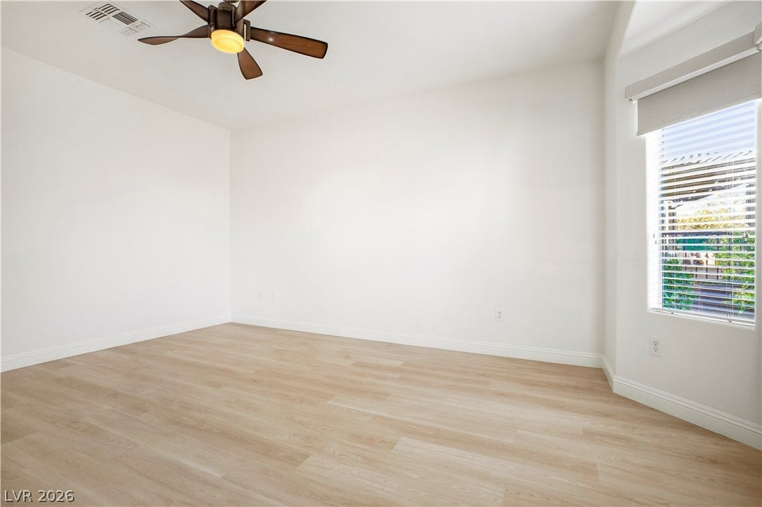 Owner's Suite with Bay Window, Ceiling Fan, Walk-In Closet w/ Organizers, and Bathroom with Raised Vanity, Dual Sinks, Shower w/ Seat, and Comfort Height Toilet w/ Bidet Heated Seat
