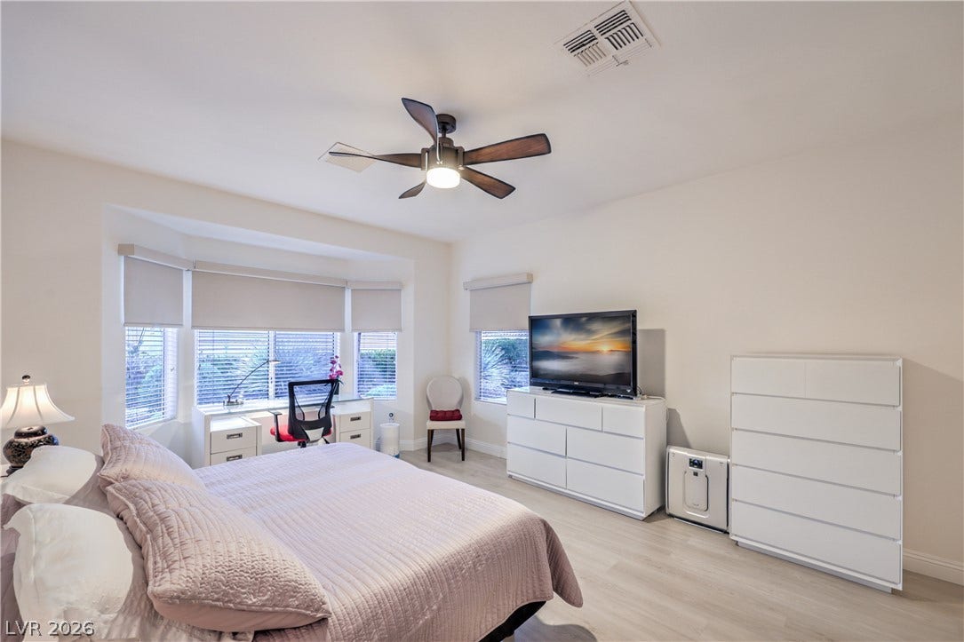 Owner's Suite with Bay Window, Ceiling Fan, Walk-In Closet w/ Organizers, and Bathroom with Raised Vanity, Dual Sinks, Shower w/ Seat, and Comfort Height Toilet w/ Bidet Heated Seat