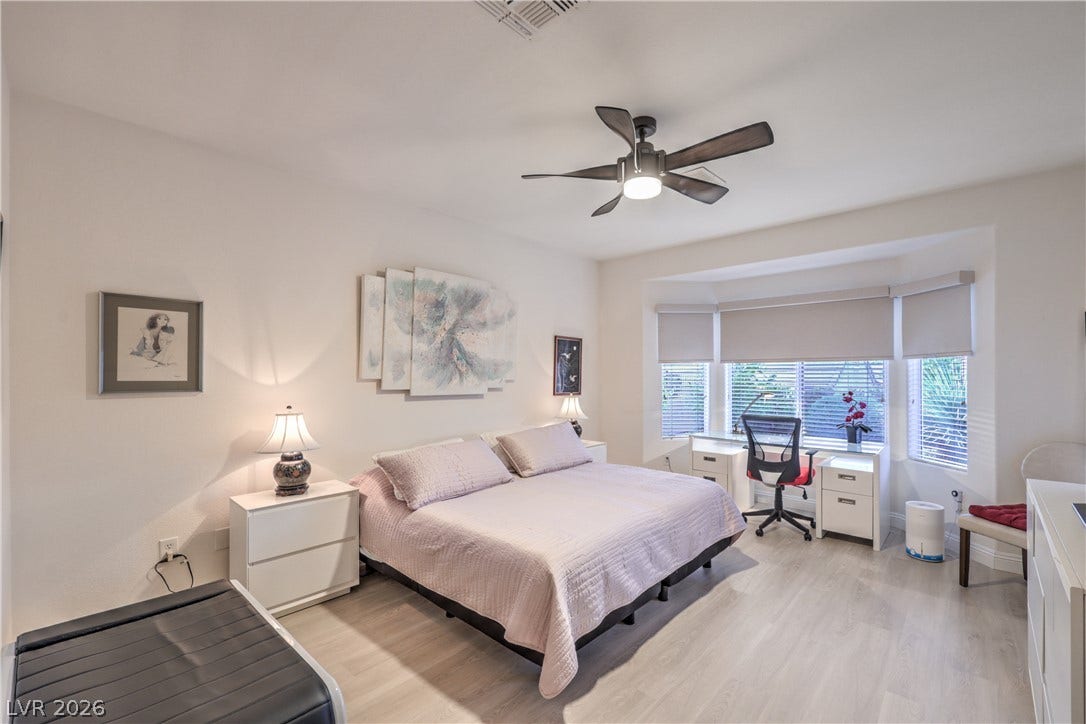Owner's Suite with Bay Window, Ceiling Fan, Walk-In Closet w/ Organizers, and Bathroom with Raised Vanity, Dual Sinks, Shower w/ Seat, and Comfort Height Toilet w/ Bidet Heated Seat